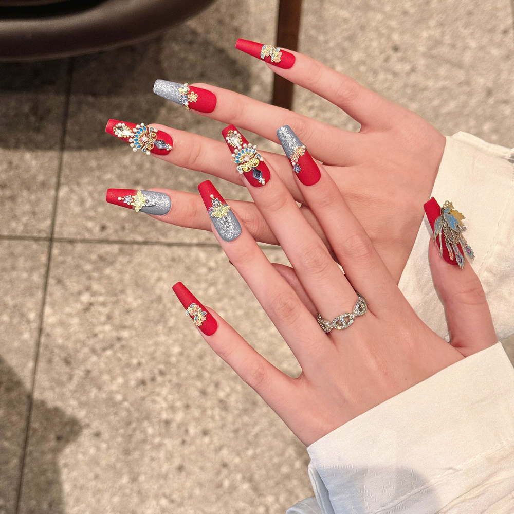A stunning set of coffin-shaped, handmade press-on nails inspired by Chinese culture, featuring red and peacock blue bases adorned with intricate phoenix and floral designs.