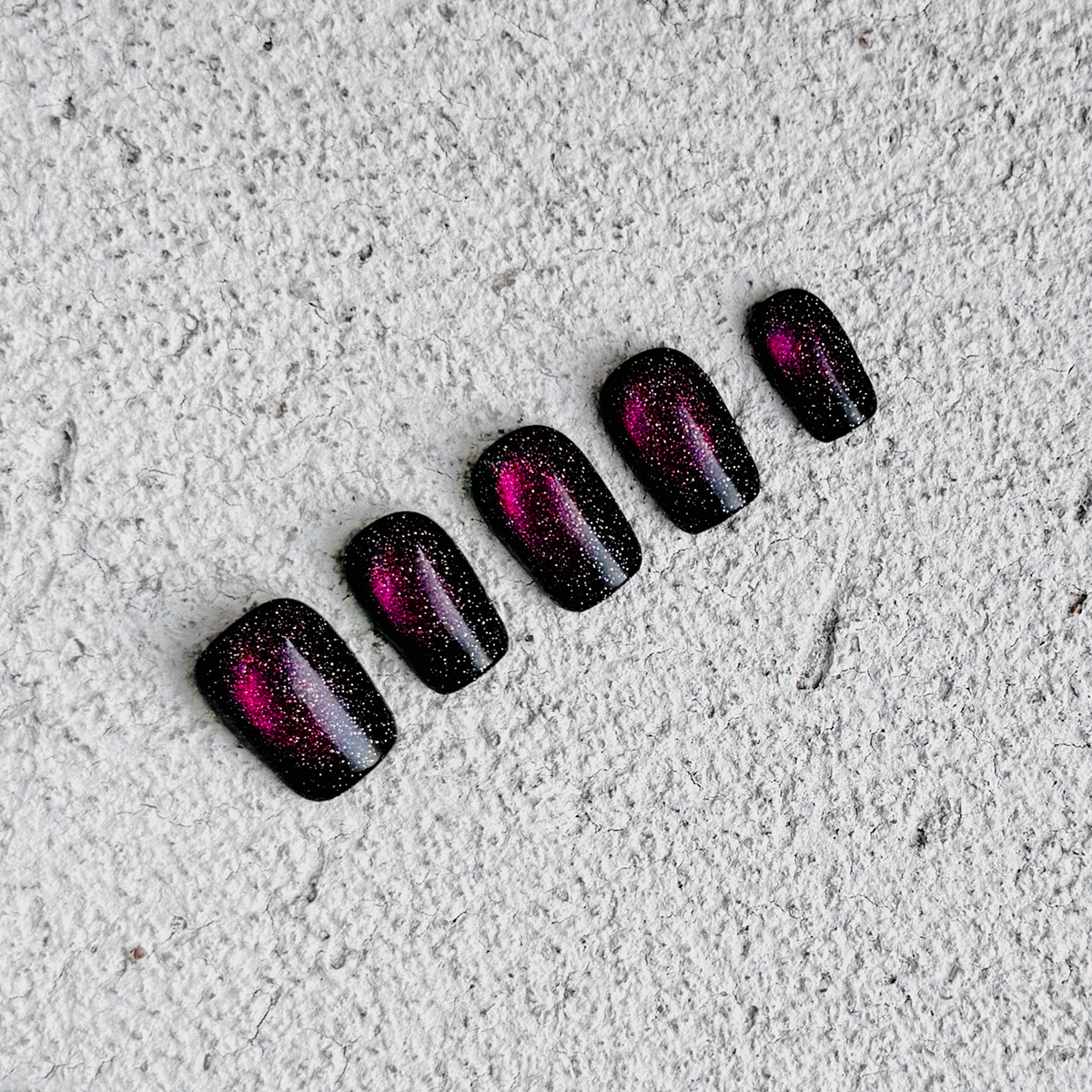 Fireworks handmade short square press-on nails with black base and multicolor cat-eye glitter, resembling fireworks in the dark night