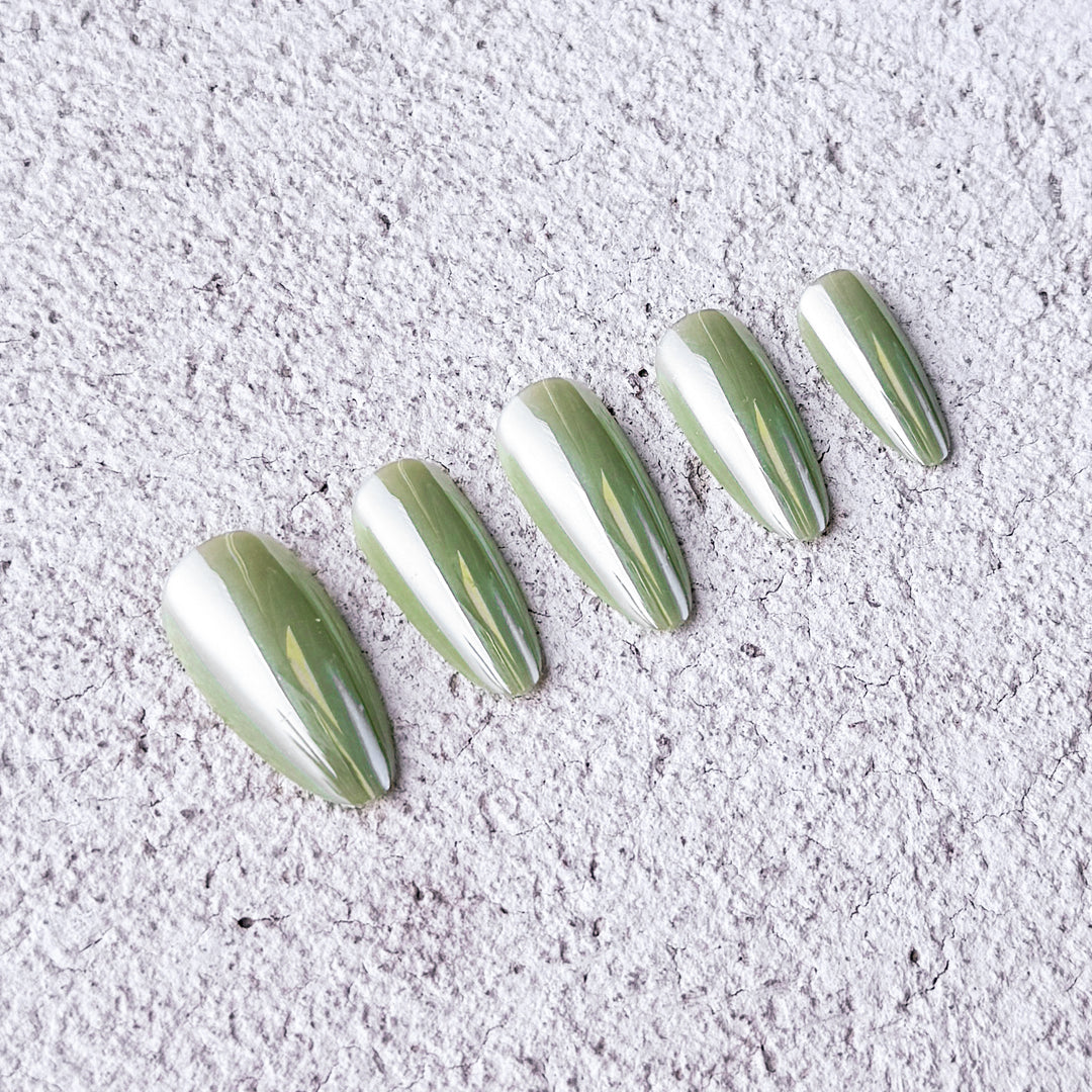 Satin glossy almond-shaped press-on nails in apple green for a fresh, trendy vibe.